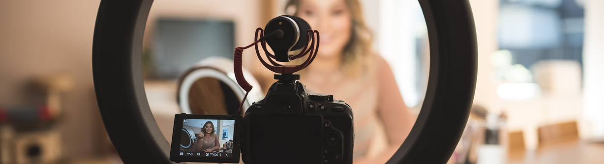 camera and light ring being used by a woman